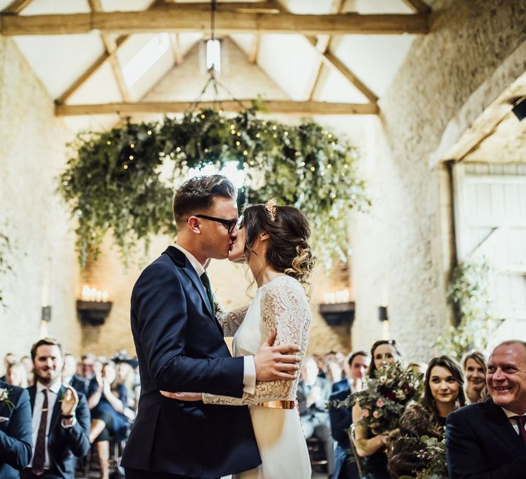 Bride and Groom at Stone Barn Wedding Ceremony Kissing