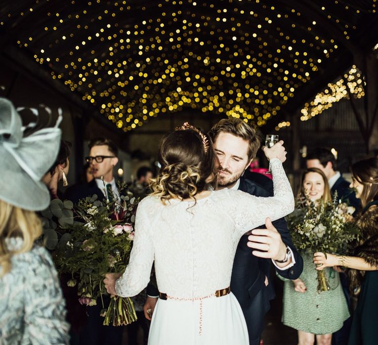 Bride in Anglet / French By Wendy Makin Wedding Dress with Long Sleeves Embracing Wedding Guests