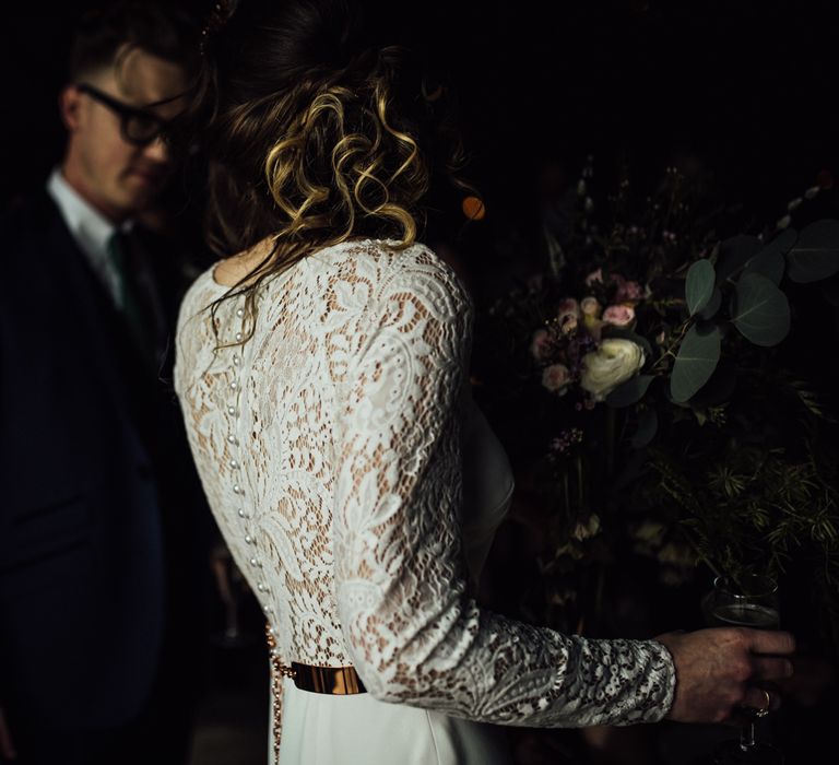 Bride in Lace Back Wedding Dress with Long Sleeves