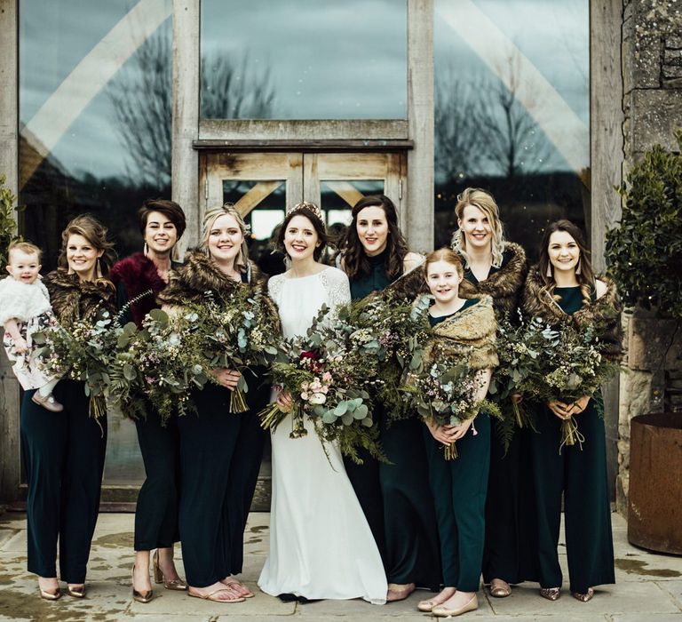 Bridal Party Portrait with Bridesmaids in Forest Green Dresses and Faux Fur Cover Ups