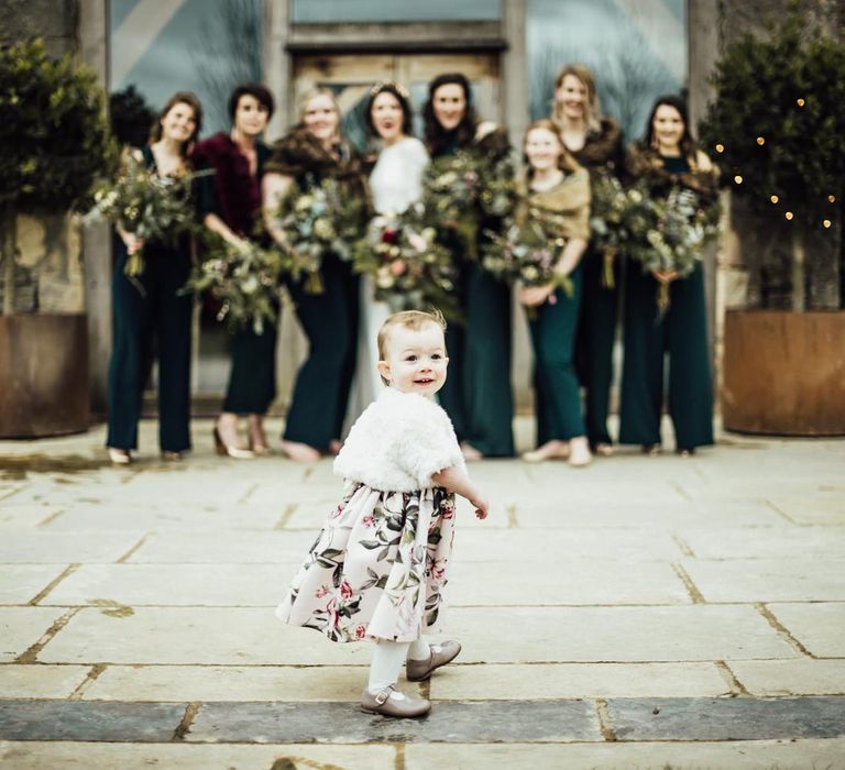 Flower Girl in Floral Dress Walking In Front of The Bridal Party