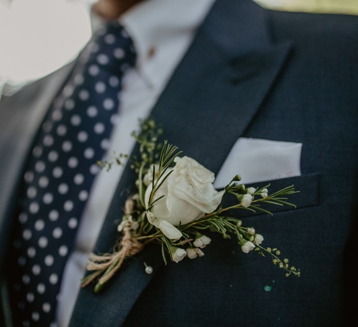 White Rose Buttonhole | Groom in Navy Blue Suit  | Macramé &amp; Dreamcatcher Woodland Wedding at Upthorpe Wood | Camilla Andrea Photography