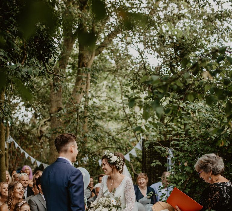 Outdoor Humanist Wedding Ceremony | Boho Bride in Flower Crown &amp; Kula Tsurdui  Wedding Dress | Groom in Navy Blue Suit  | Macramé &amp; Dreamcatcher Woodland Wedding at Upthorpe Wood | Camilla Andrea Photography