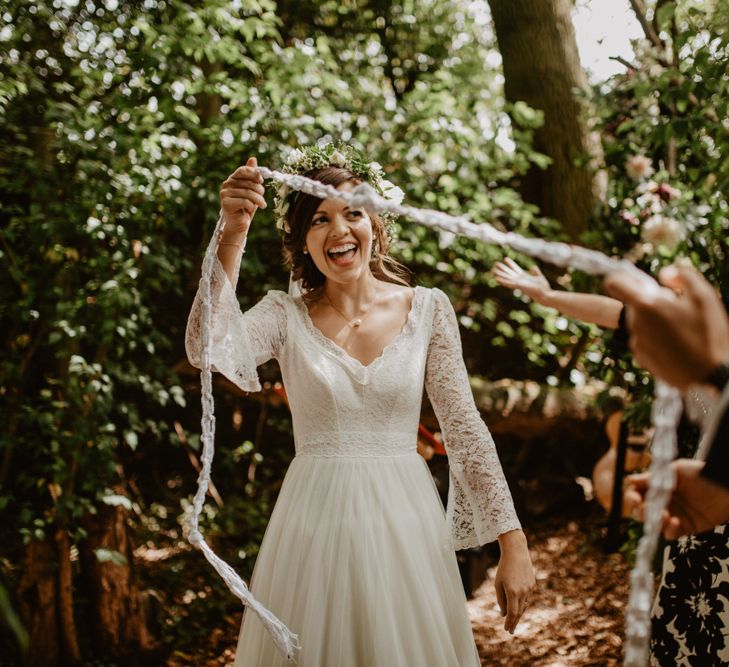 Outdoor Humanist Wedding Ceremony | Boho Bride in Flower Crown &amp; Kula Tsurdui  Wedding Dress | Groom in Navy Blue Suit  | Macramé &amp; Dreamcatcher Woodland Wedding at Upthorpe Wood | Camilla Andrea Photography