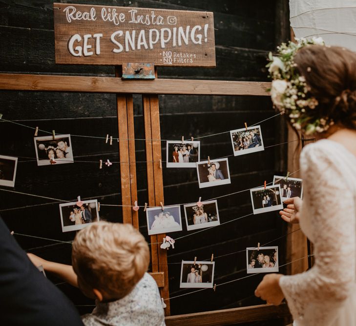 Polaroid Picture Wedding Guest Book | Boho Bride in Flower Crown &amp; Kula Tsurdui  Wedding Dress | Macramé &amp; Dreamcatcher Woodland Wedding at Upthorpe Wood | Camilla Andrea Photography