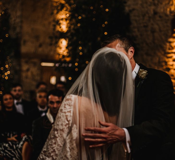 Groom Kissing his Bride at The Altar