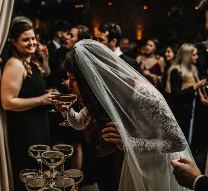 Bride in Lace Long Sleeve Made With Love Bridal Wedding Dress Drinking Champagne