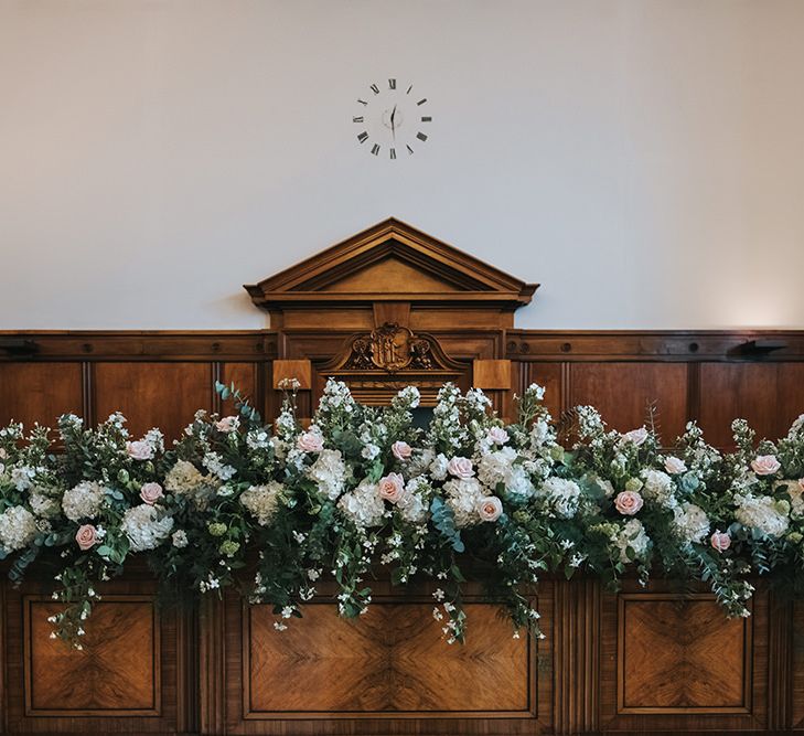 Blush and White Flowers with Foliage Altar Arrangement | Wedding Ceremony at Town Hall Hotel | Statement Floral Arrangement Altar and Potted Plants with Copper Frame Table Plan and Lace Jacket | Miss Gen Photography