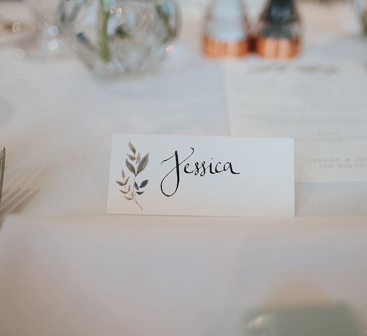 Papier Place Cards | Statement Floral Arrangement Altar and Potted Plants with Copper Frame Table Plan and Lace Jacket | Miss Gen Photography