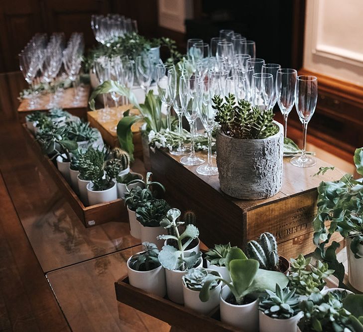 Champagne Table Decorated with Succulents and Wooden Crates | Wedding Reception at Town Hall Hotel | Statement Floral Arrangement Altar and Potted Plants with Copper Frame Table Plan and Lace Jacket | Miss Gen Photography