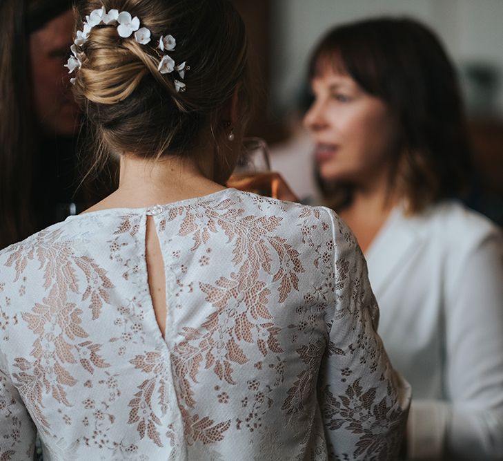 Bridal Lace Jacket by Charlie Brear | Porcelain Floral Hairpiece by Eden B | Statement Floral Arrangement Altar and Potted Plants with Copper Frame Table Plan and Lace Jacket | Miss Gen Photography