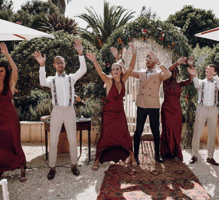 Wedding party waving their arms at the altar