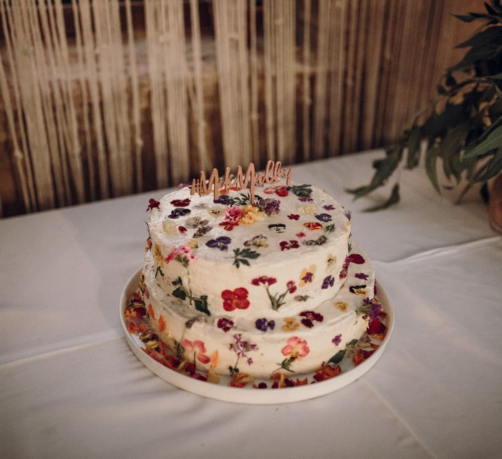 Edible flower cake table with wooden cake topper