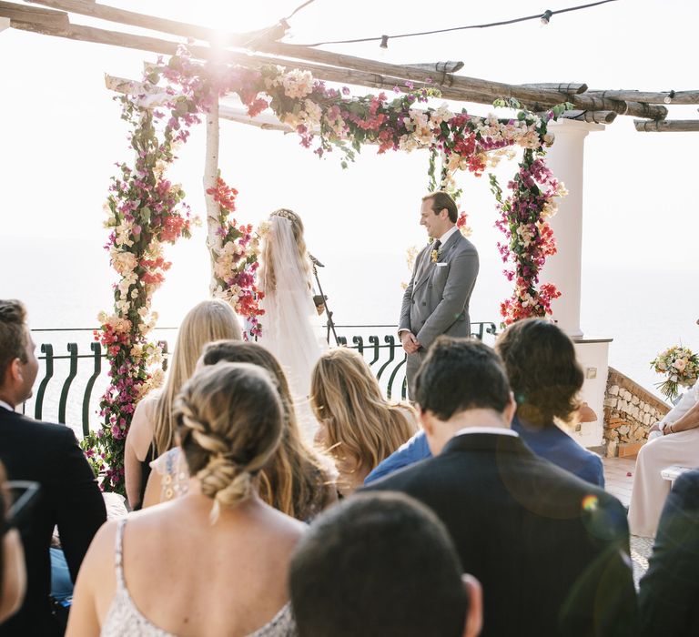 Costal Capri Wedding Ceremony with Altar Covered in Pink Flowers