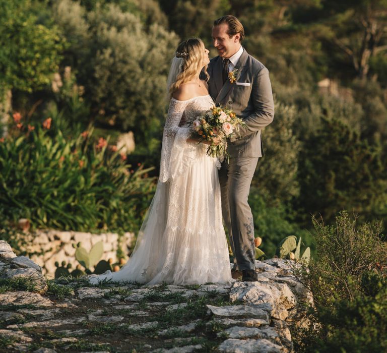 Bride in Bardot Tulle and Lace Flora Bridal Wedding Dress and Groom in Grey Ralph Lauren Suit