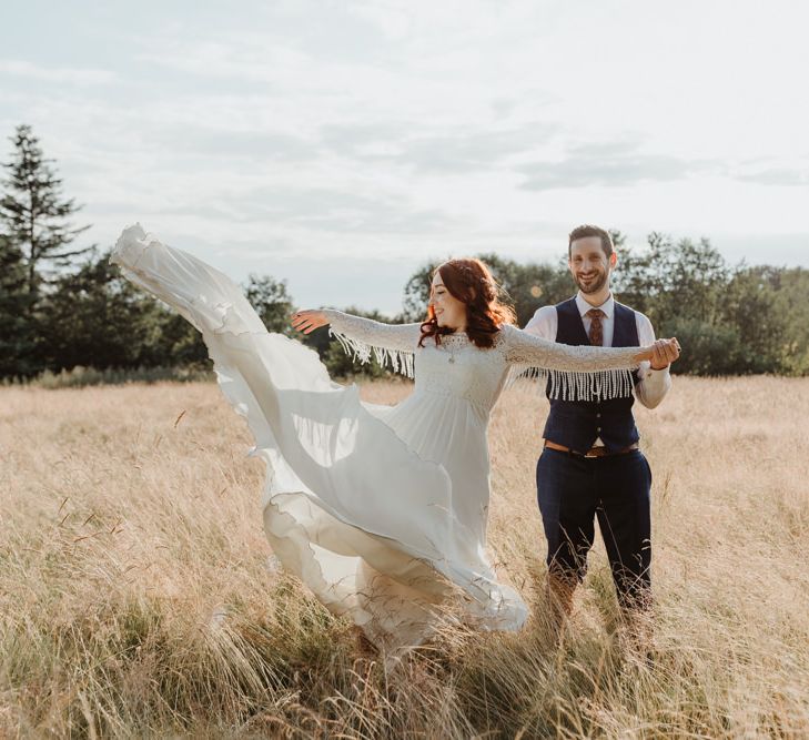 Bride Shows Off Fringed Detail On Arm Of Dress