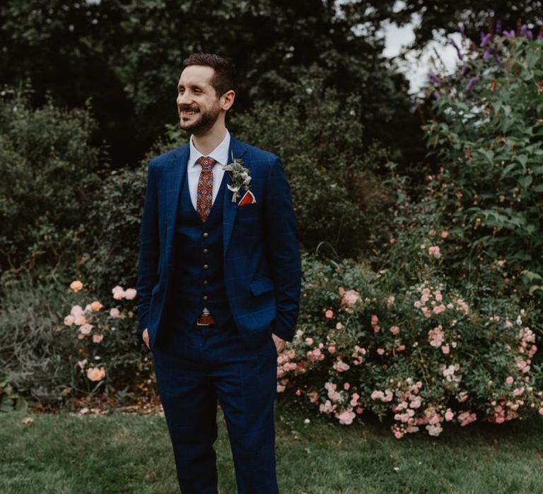 Groom In Navy Moss Bros Suit With Patterned Tie