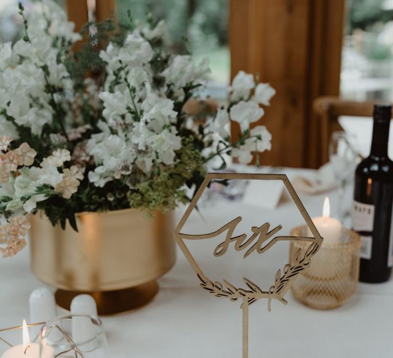 Gold Table Numbers and White Flowers in Gold Vase