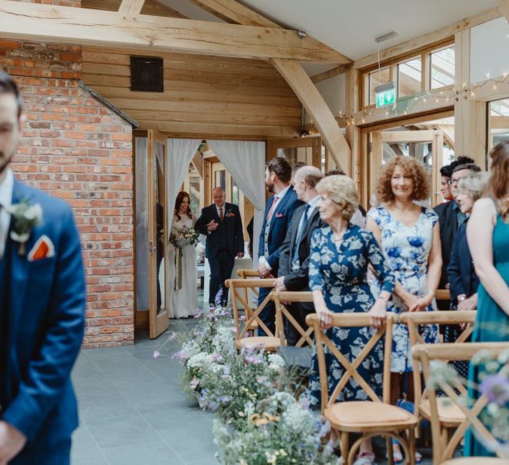 Groom In Navy Suit Waiting For Bride at Altar