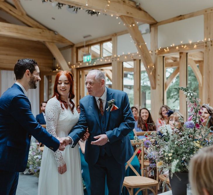 Groom Shakes Father Of Bride's Hand At Altar