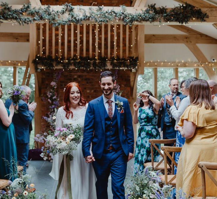 Bride and Groom Walk Back Up The Aisle After Saying I Do