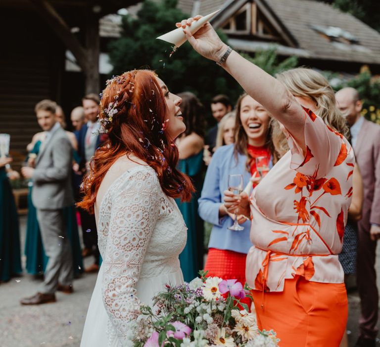 Guest Pours Leftover Confetti On Bride