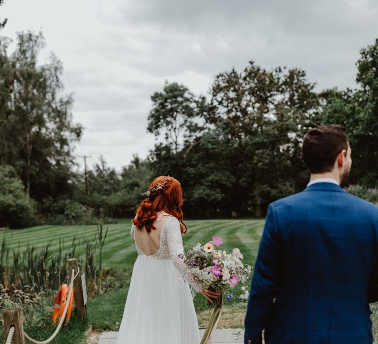 Bride In Lucy Can't Dance Wedding Dress Carrying Wildflower Bouquet