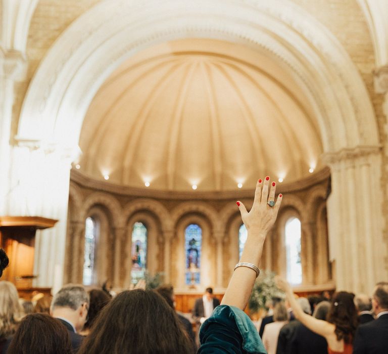 Wedding Guest Raising Her Hand During the Wedding Ceremony