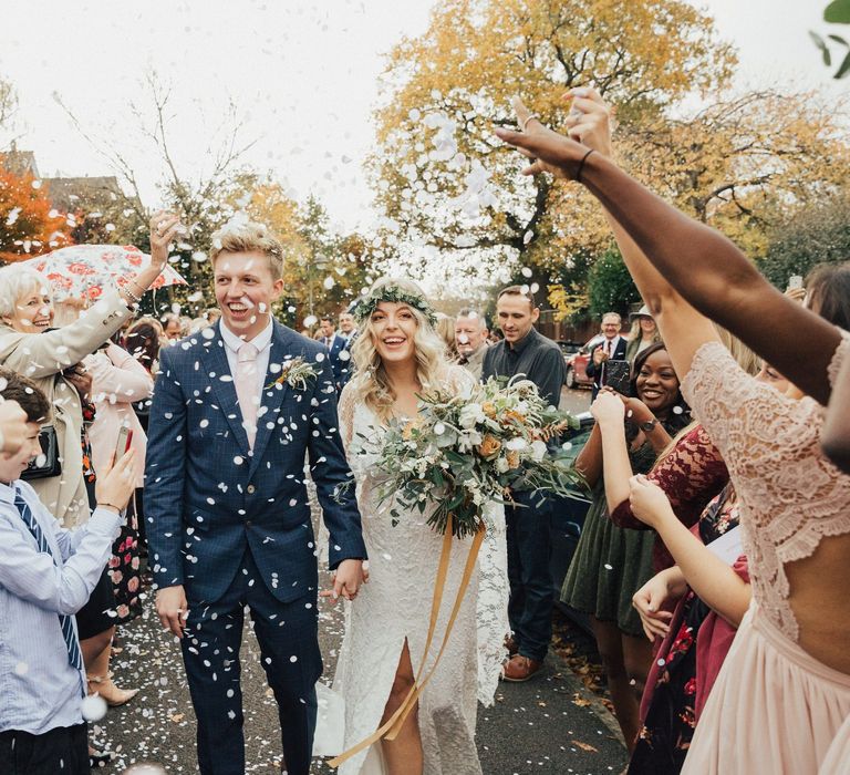 Confetti Moment with Bride in Boho Wedding Dress and Groom in Navy Suit