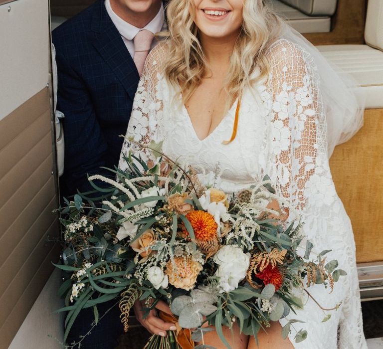 Boho Bride and Groom Sitting in a Camper Van Wedding Car