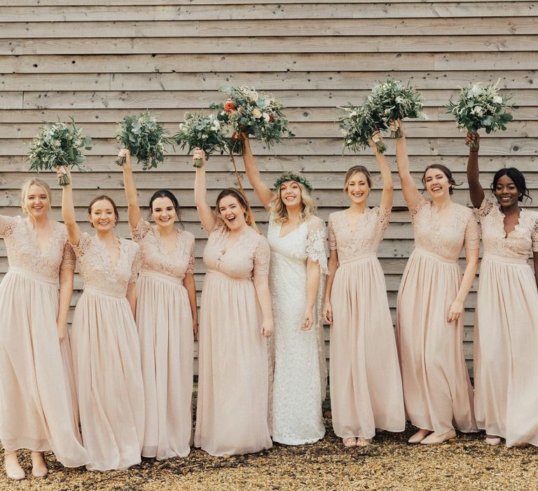 Bridal Party Portrait with Bride and Bridesmaids Waving Their Bouquets in the Air