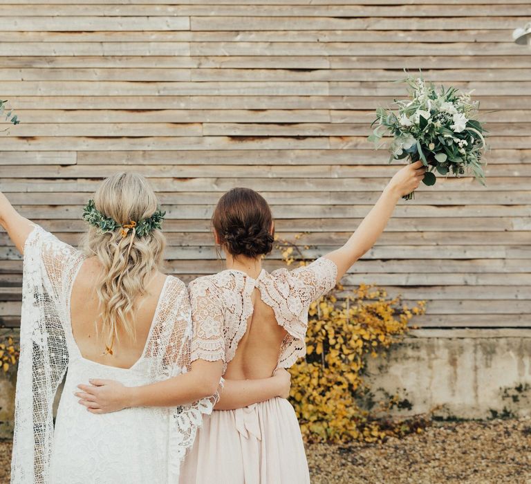 Boho Bride in Grace Loves Lace Wedding Dress and Bridesmaid in Backless Pink Lace ASOS Dress