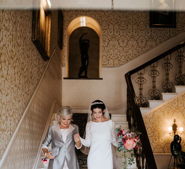 Mother of the bride and bride walk down the stairs of the petersham hotel in richmond and head towards wedding car