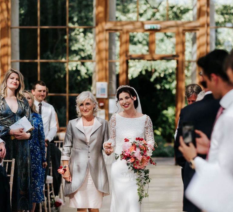 Bride and mother of the bride walk down the aisle