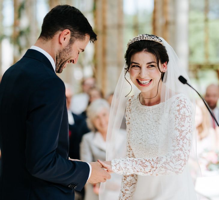 Groom puts ring on bride at Kew Gardens wedding