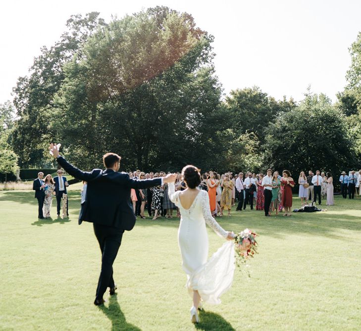 Guests enjoy drinks on the lawn at summer Kew Gardens wedding