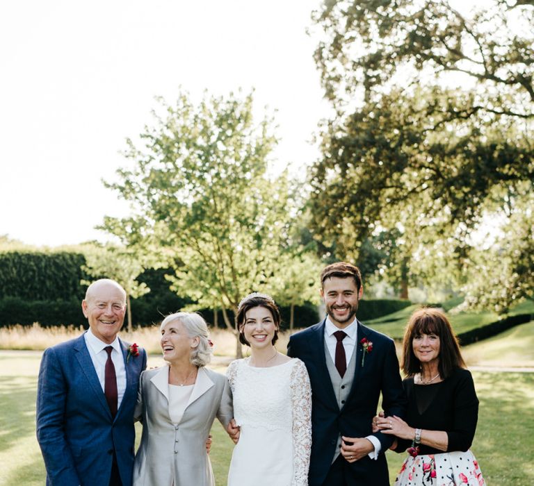 Bride and groom with family at summer wedding