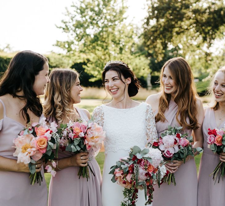 Pink bridesmaid dresses with pink flower bouquets