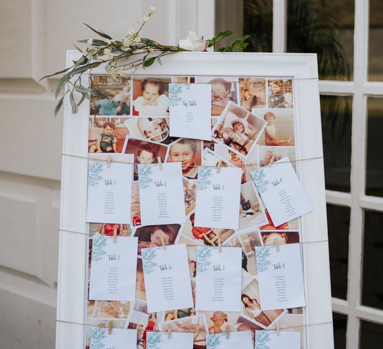 Wedding table seating chart with couple photographs behind