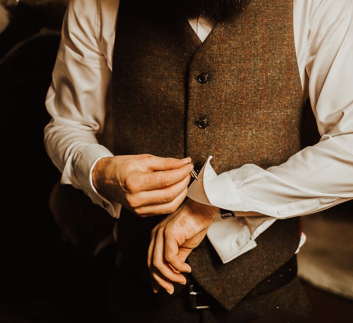 Groom in tweed waistcoat getting ready for Snowdonia wedding