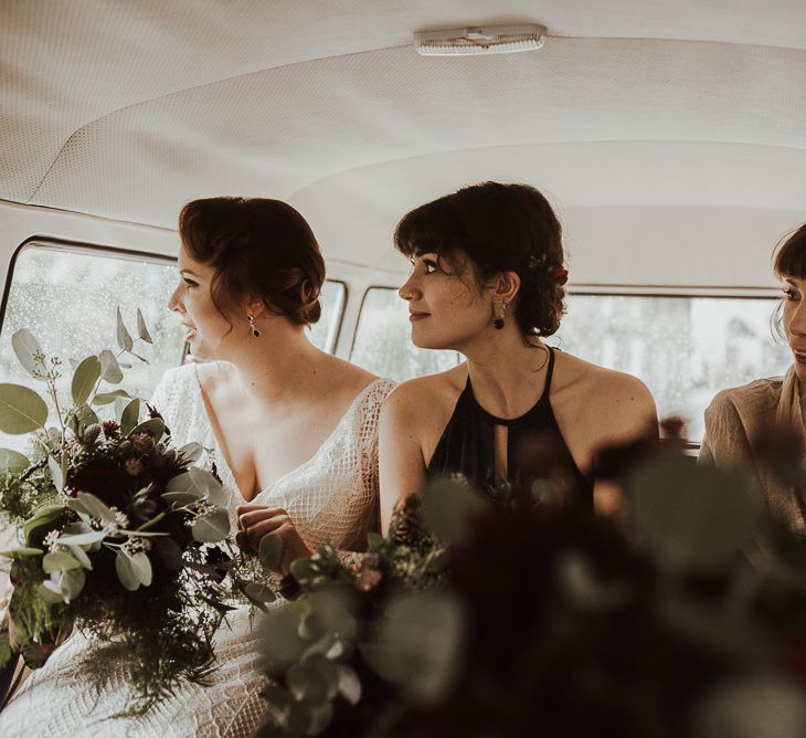 Bride and bridesmaids on way to ceremony with foliage bouquets