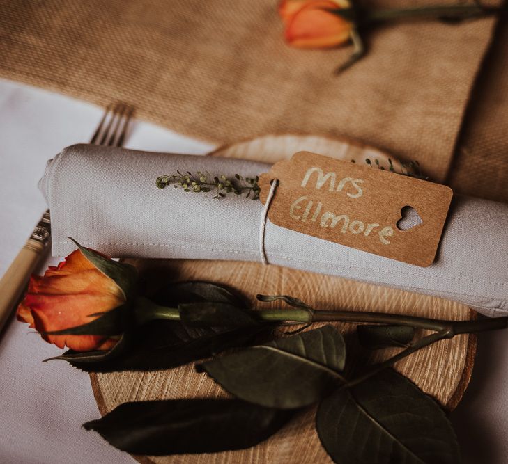 Orange wedding flower and herb wedding place setting