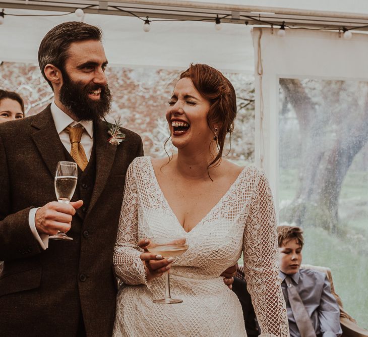 Bride and groom enjoy wedding speeches