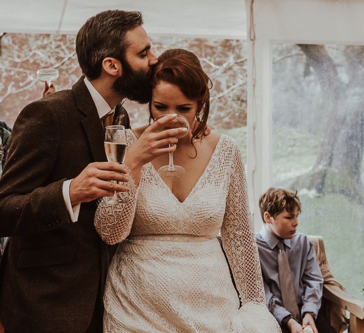 Bride and groom enjoy wedding speeches