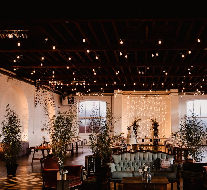 Festoon Lights | Hanging Paper Cranes | Vintage Sofas | Wooden Trestle Tables | Indoor Trees | Trinity Buoy Wharf Wedding Venue | String Lights, Perspex Table Signs and Paper Cranes for Industrial Wedding | Frankee Victoria Photography