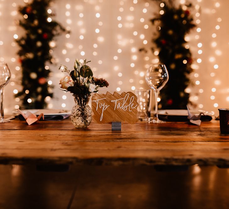 Copper and Perspex Table Sign | Wooden Top Table | Festoon Lights | Flowers and Foliage in Bud Vase | Paper Crane Place Settings | Copper Tea Light Candle Holders | Trinity Buoy Wharf Wedding Venue | String Lights, Perspex Table Signs and Paper Cranes for Industrial Wedding | Frankee Victoria Photography