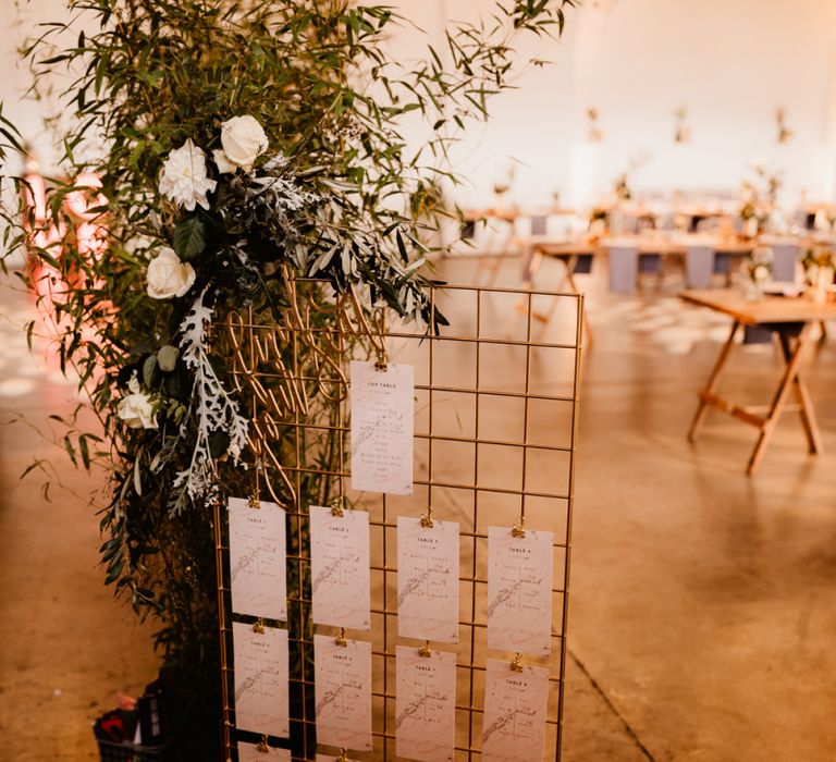 Copper Grid Table Plan | Foliage and White Flowers | Trinity Buoy Wharf Wedding Venue | String Lights, Perspex Table Signs and Paper Cranes for Industrial Wedding | Frankee Victoria Photography