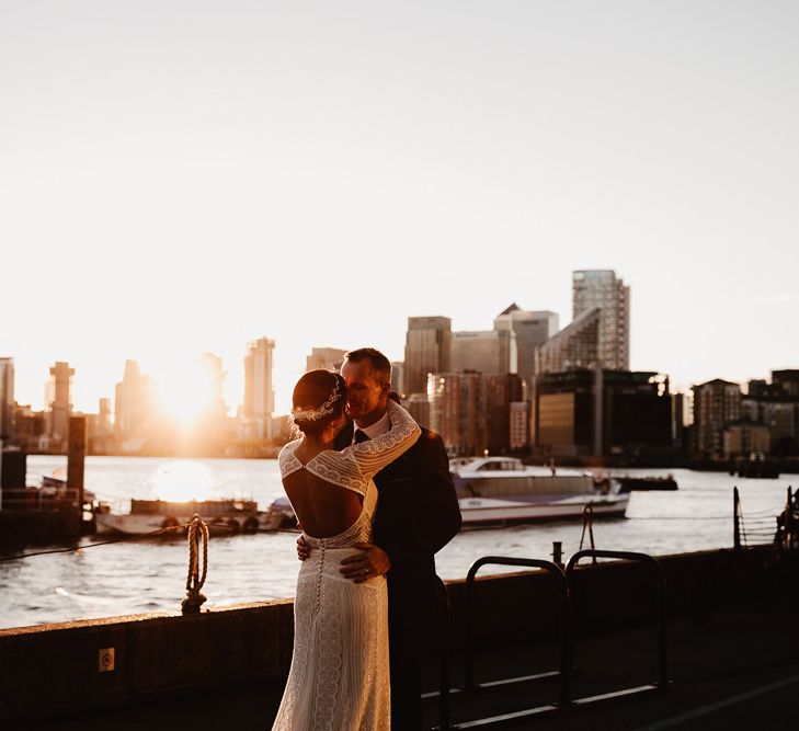 Bride in Lenora Dress by Wtoo Watters with Lace Sleeves and Keyhole Back | Prudence Halo Headpiece by Kelly Spence Wed | Groom in Navy Suit with Grey Waistcoat from Jack Bunneys | String Lights, Perspex Table Signs and Paper Cranes for Industrial Wedding | Frankee Victoria Photography