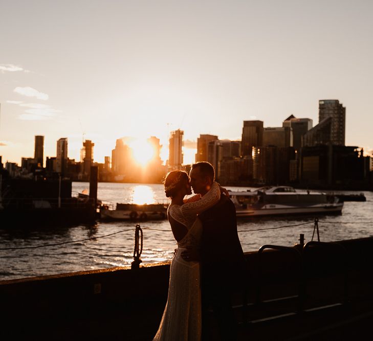 Bride in Lenora Dress by Wtoo Watters with Lace Sleeves and Keyhole Back | Prudence Halo Headpiece by Kelly Spence Wed | Groom in Navy Suit with Grey Waistcoat from Jack Bunneys | String Lights, Perspex Table Signs and Paper Cranes for Industrial Wedding | Frankee Victoria Photography