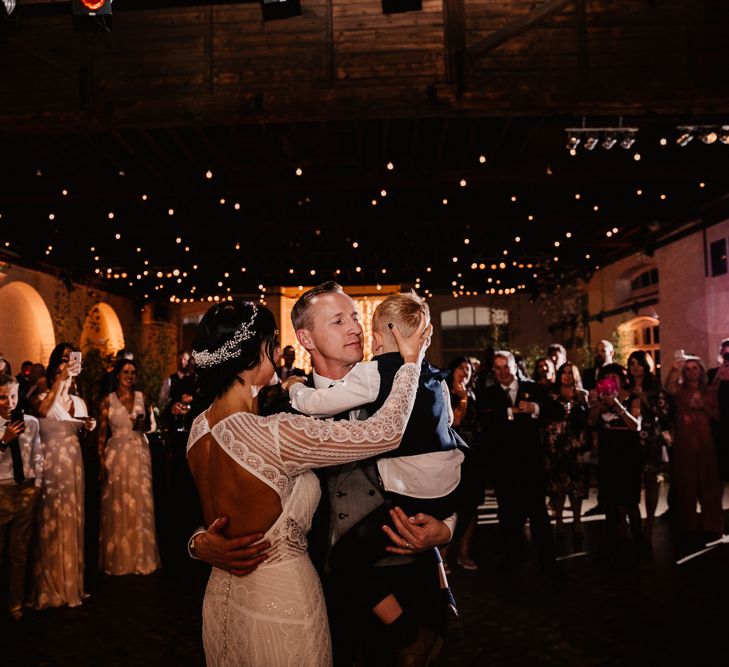 Bride in Lenora Dress by Wtoo Watters with Lace Sleeves and Keyhole Back | Prudence Halo Headpiece by Kelly Spence Wed | Groom in Navy Suit with Grey Waistcoat from Jack Bunneys | Trinity Buoy Wharf Wedding Venue | First Dance | String Lights, Perspex Table Signs and Paper Cranes for Industrial Wedding | Frankee Victoria Photography